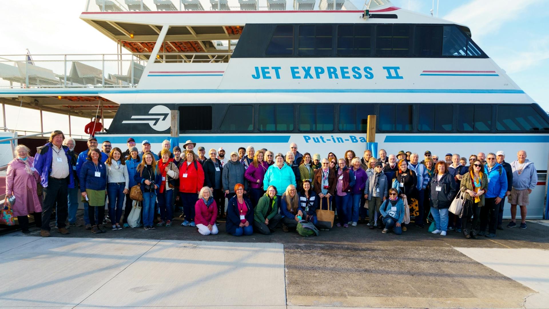 Representatives from the Great Lakes Island Alliance meet in Ohio next to a ferry boat.