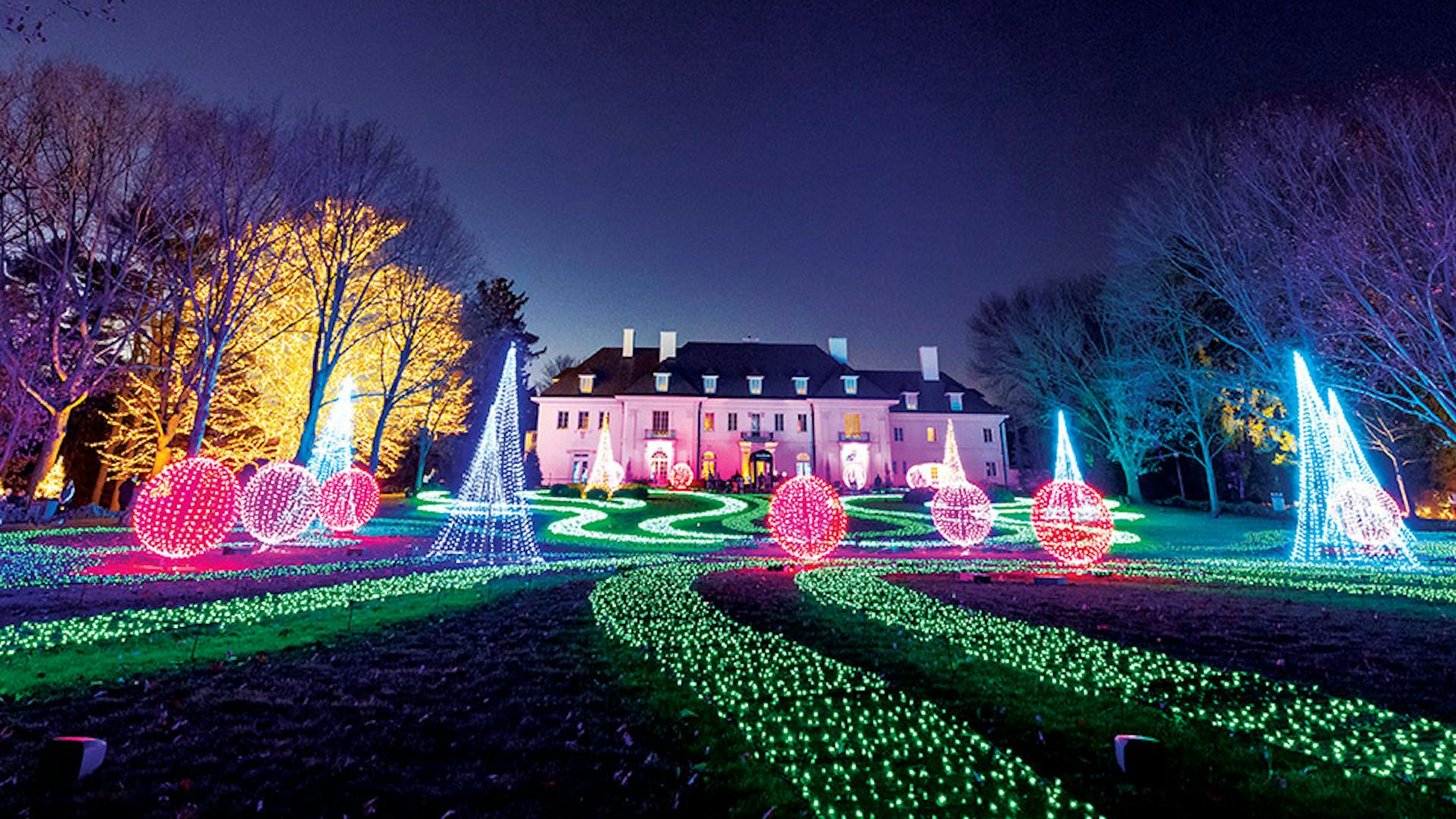 Illuminated trees, garden and mansion at Winterlights at Newfields in Indianapolis, Indiana (photo courtesy of Newfields)