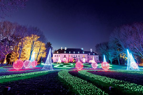 Illuminated trees, garden and mansion at Winterlights at Newfields in Indianapolis, Indiana (photo courtesy of Newfields)