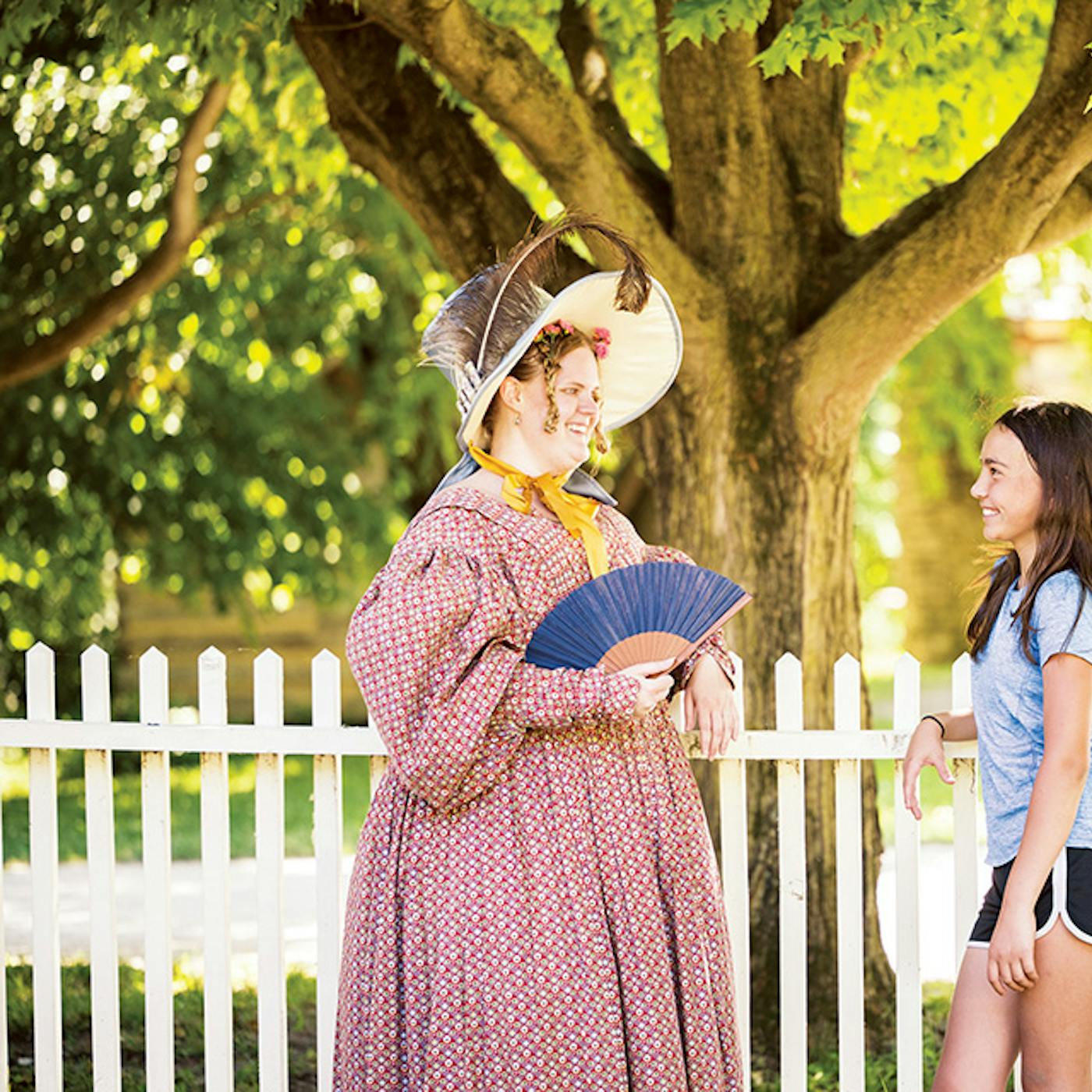 A costumed historical interpreter and visitor at Conner Prairie in Fishers, Indiana (photo by Aimed Photography LLC))