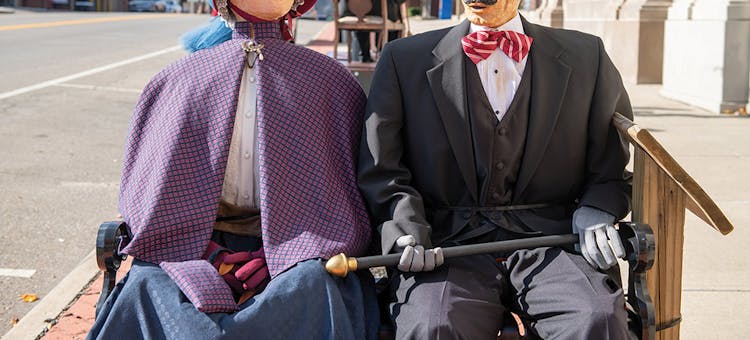 Life-size figures on bench at Dickens Victorian Village in Cambridge, Ohio (photo courtesy of Cambridge/Guernsey County CVB)