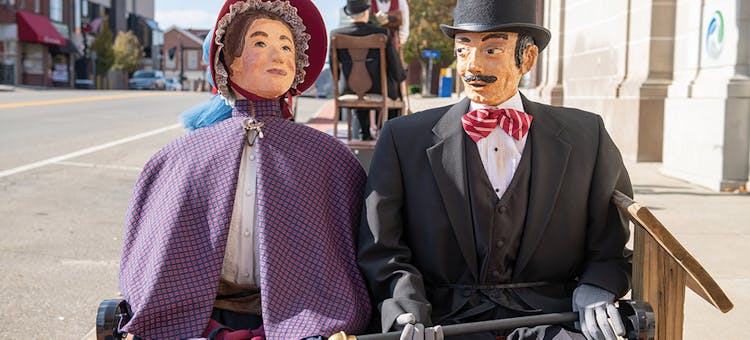 Life-size figures on bench at Dickens Victorian Village in Cambridge, Ohio (photo courtesy of Cambridge/Guernsey County CVB)