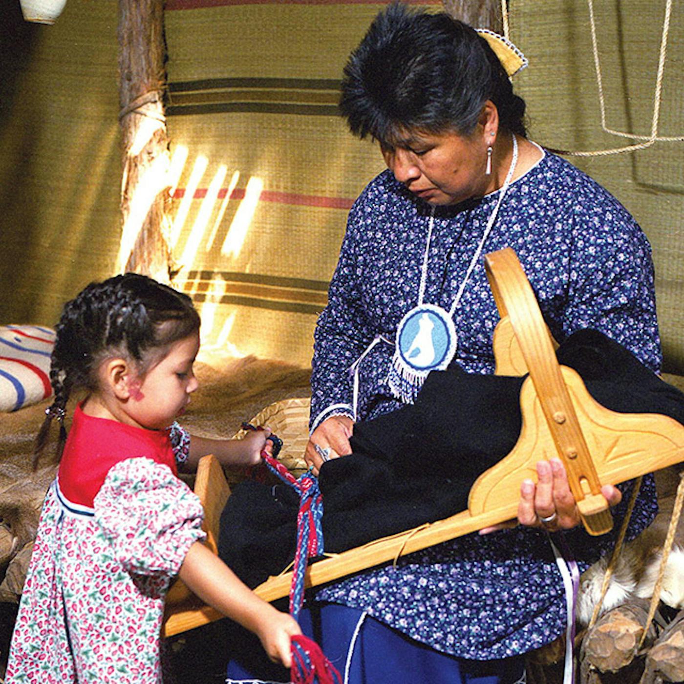 Interpreter talking with young girl at Ganondagan State Historic Site in Victor, New York (photo courtesy of Finger Lakes Visitors Connection))