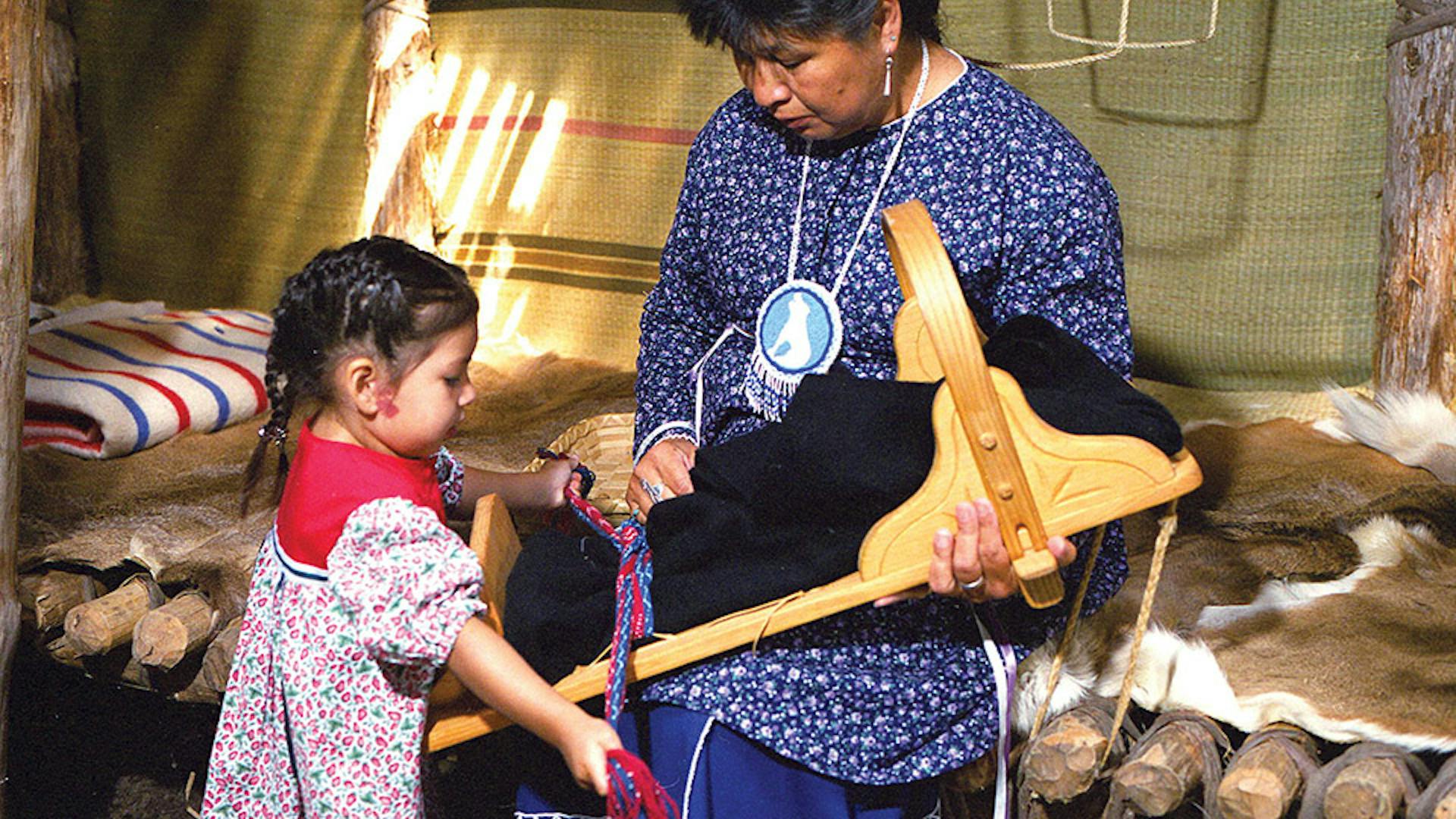 Interpreter talking with young girl at Ganondagan State Historic Site in Victor, New York (photo courtesy of Finger Lakes Visitors Connection)