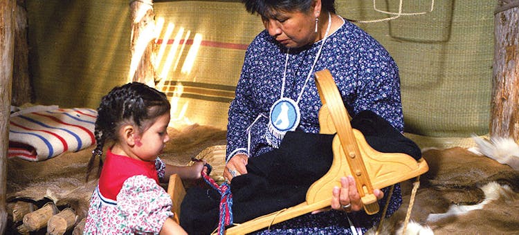 Interpreter talking with young girl at Ganondagan State Historic Site in Victor, New York (photo courtesy of Finger Lakes Visitors Connection)