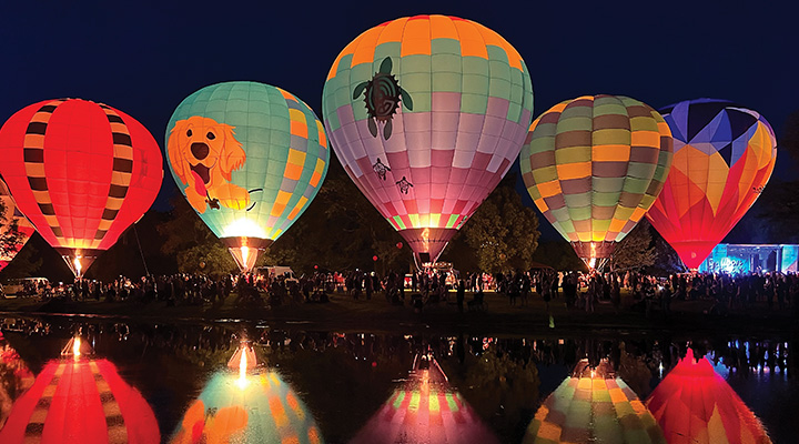 Illuminated balloons reflected in water at Centralia Balloon Fest in Centralia, Illinois (photo courtesy of Centralia Balloon Fest)