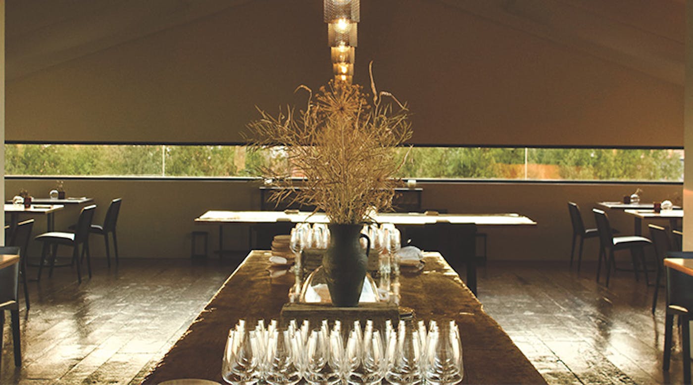 Rustic tables and wine glasses at Restaurant Pearl Morissette in Jordan Station, Ontario (photo courtesy of Restaurant Pearl Morissette))