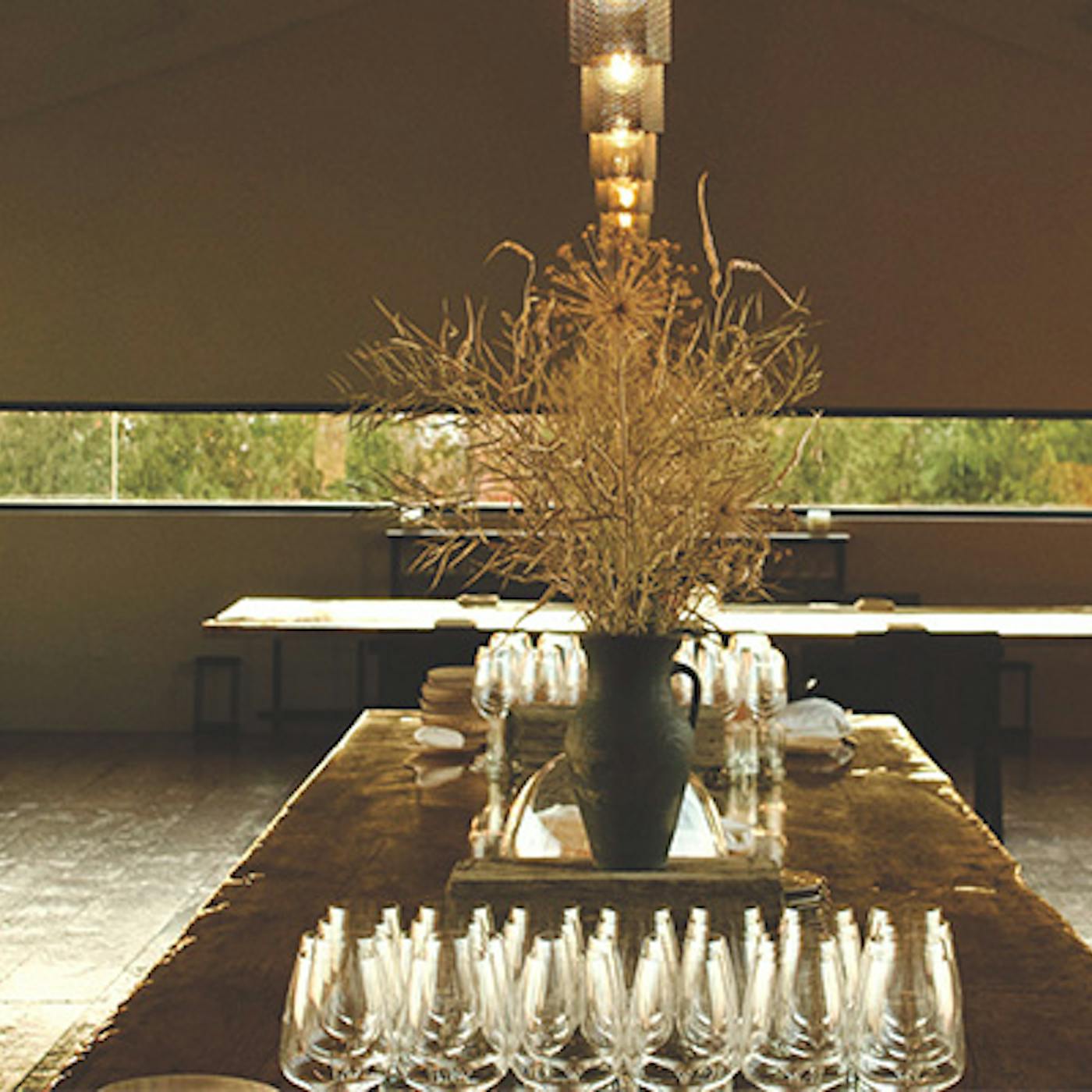 Rustic tables and wine glasses at Restaurant Pearl Morissette in Jordan Station, Ontario (photo courtesy of Restaurant Pearl Morissette))