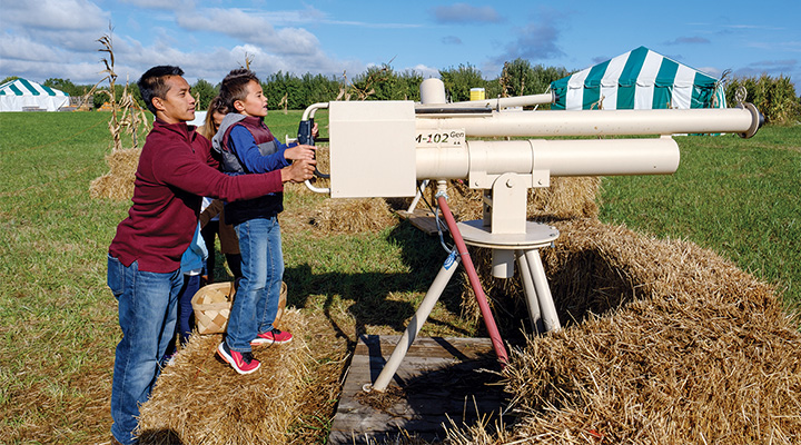 Dad and son using apple cannon at Heartland Apple Festival in Danville, Indiana (photo courtesy of Heartland Apple Festival)