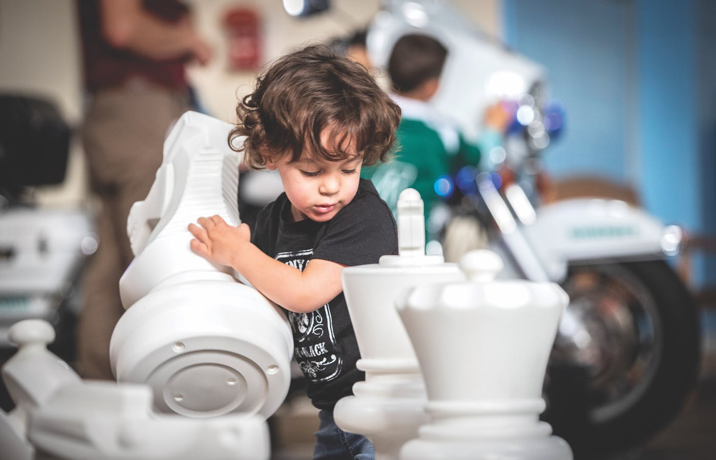 Child playing with giant chess set at Children's Museum Of Memphis in Memphis, Tennessee (photo by Disciple Photo)