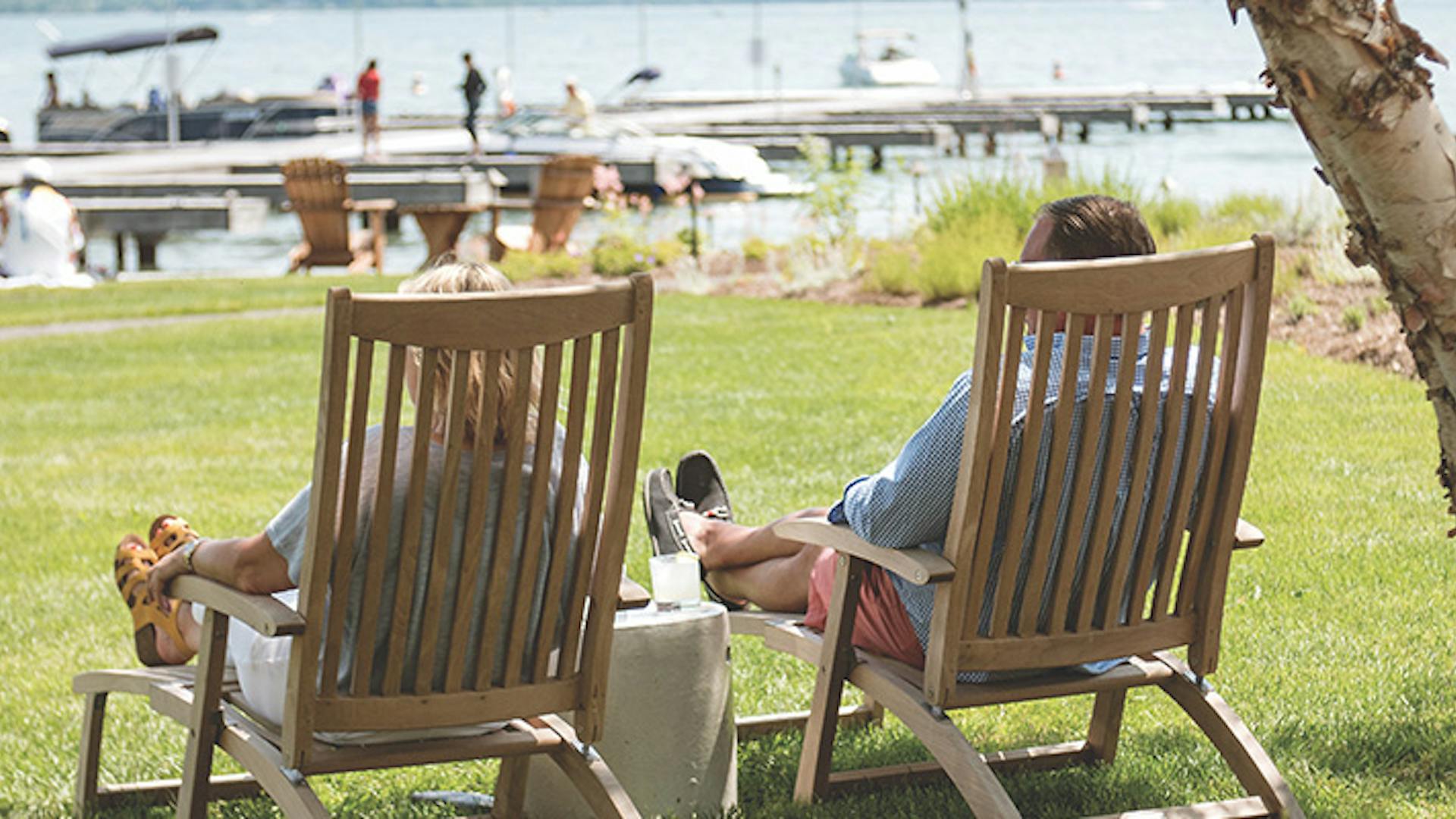 Couple sitting in lawn chairs lakeside at The Lake House on Canandaigua in Canandaigua, New York (photo courtesy of The Lake House on Canandaigua)