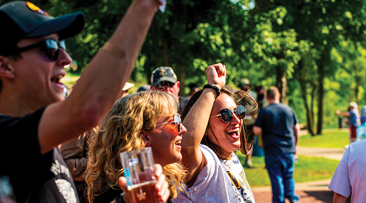 People cheering while holding beers at Mountaineer Brewfest in Wheeling, West Virginia (photo courtesy of Mountaineer Brewfest)