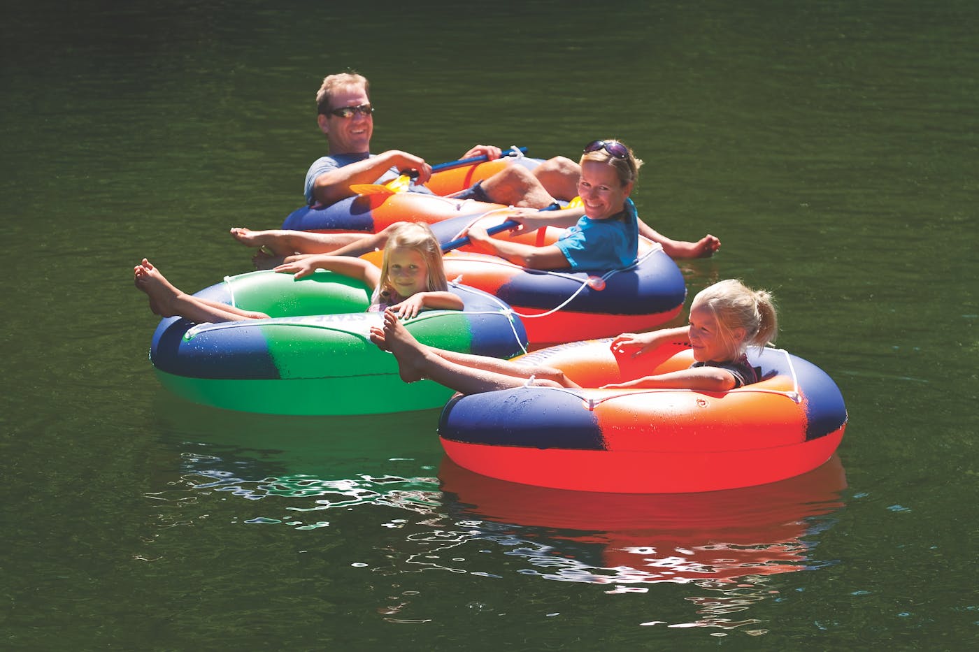 Family floating in inner tubes on the Big Sable River in Ludington, Michigan (photo by Todd Reed))