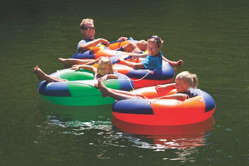 Family floating in inner tubes on the Big Sable River in Ludington, Michigan (photo by Todd Reed)
