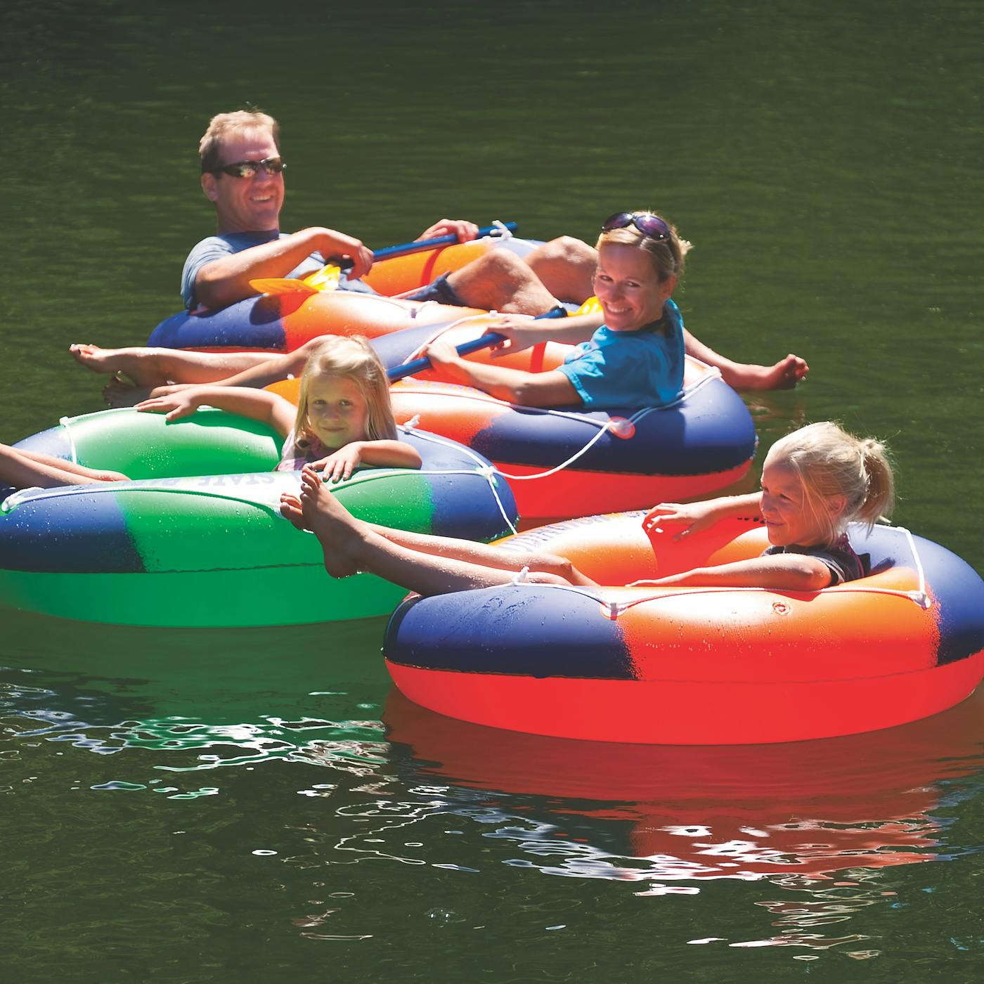 Family floating in inner tubes on the Big Sable River in Ludington, Michigan (photo by Todd Reed))
